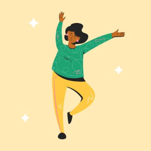 joyful woman dancing in front of yellow background